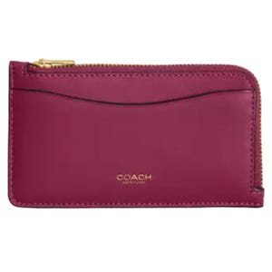 Burgundy leather Coach wallet with a gold-tone zipper and \“Coach New York\“ logo.