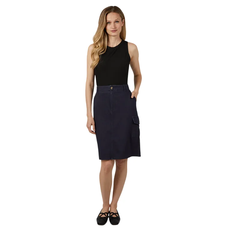 A woman is wearing a black sleeveless top paired with a navy knee-length cargo skirt and black shoes. The skirt features a side pocket with a button closure.