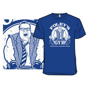Blue T-shirt with a graphic of a man at a gym with text \“Foley's Gym\“ and \“Get Motivated in a Van Down by the River\“. The design also features the years \“19\“ and \“93\“.