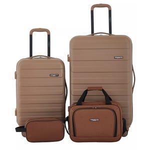 A beige four-piece luggage set from Travelers Club includes two wheeled suitcases with handles, a carry-on bag, and a toiletry bag.