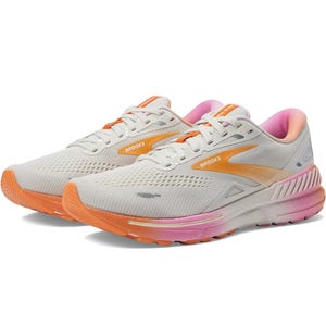 A pair of Brooks running shoes, featuring a gray and orange color scheme with pink accents.