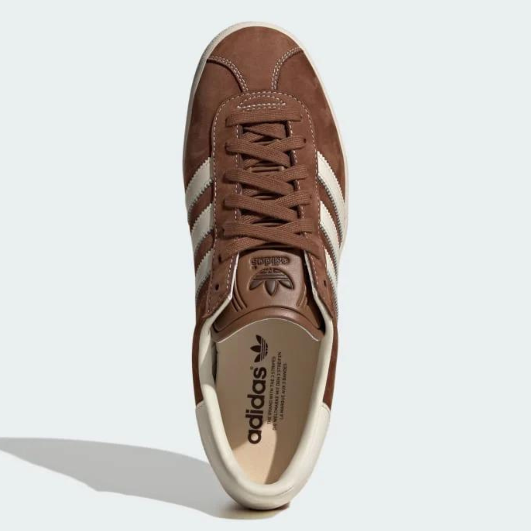 A single brown and white Adidas sneaker with laces.