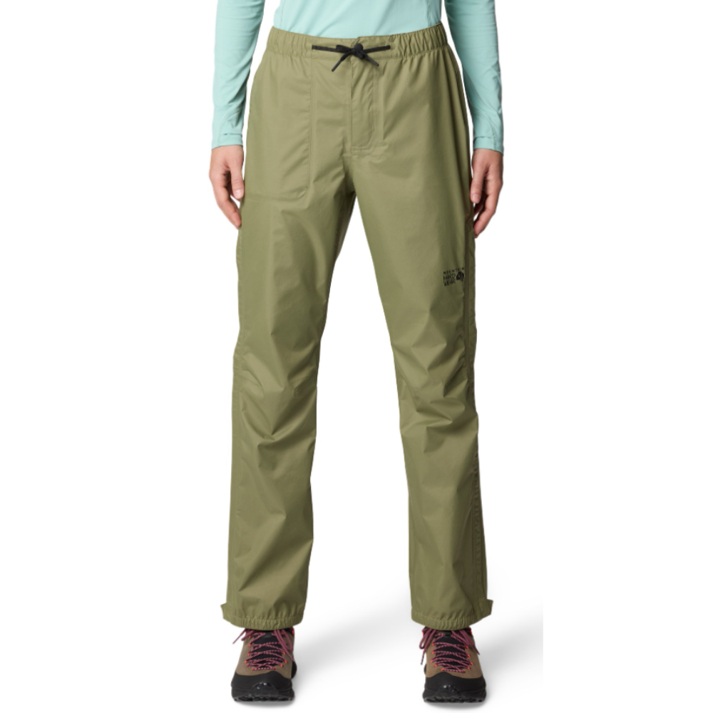 A person is wearing olive green outdoor pants with an elastic waistband and drawstring. They have hiking boots on, featuring pink laces.