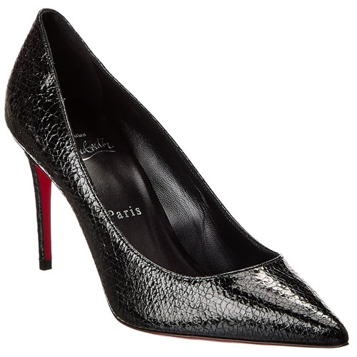 A black, textured leather stiletto heel with a pointed toe and a red sole.