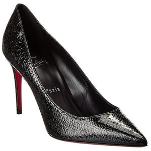 A black, textured leather stiletto heel with a pointed toe and a red sole.