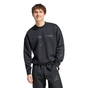 Adidas New Z.N.E. Sweater features a sleek black design with subtle tonal branding. It has a relaxed fit, long sleeves, and a crew neck, offering a comfortable and sporty look.