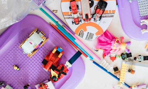 a various assortment of pink and purple blocks, toys, and figurines