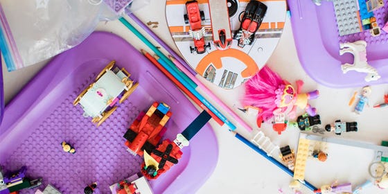 a various assortment of pink and purple blocks, toys, and figurines