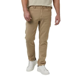 A person wearing beige pants with a button closure and pockets, along with white sneakers, and a beige shirt.