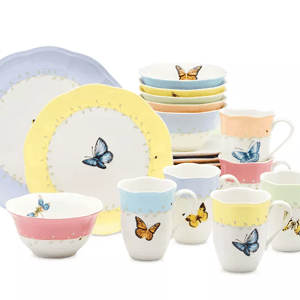 24-piece Lenox dinnerware set features plates, bowls, and mugs adorned with colorful butterfly and floral designs, presented in pastel hues of yellow, blue, pink, and green.