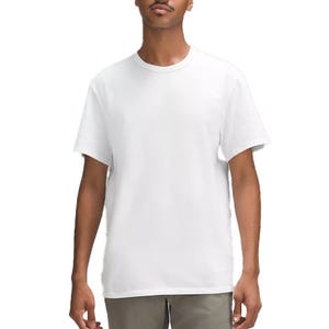 White cotton jersey t-shirt, short-sleeved, crew neck, with a relaxed fit. Paired with olive green pants.