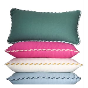 Stacked cushions in green, pink, white, and blue with herringbone patterns and twisted rope edges.