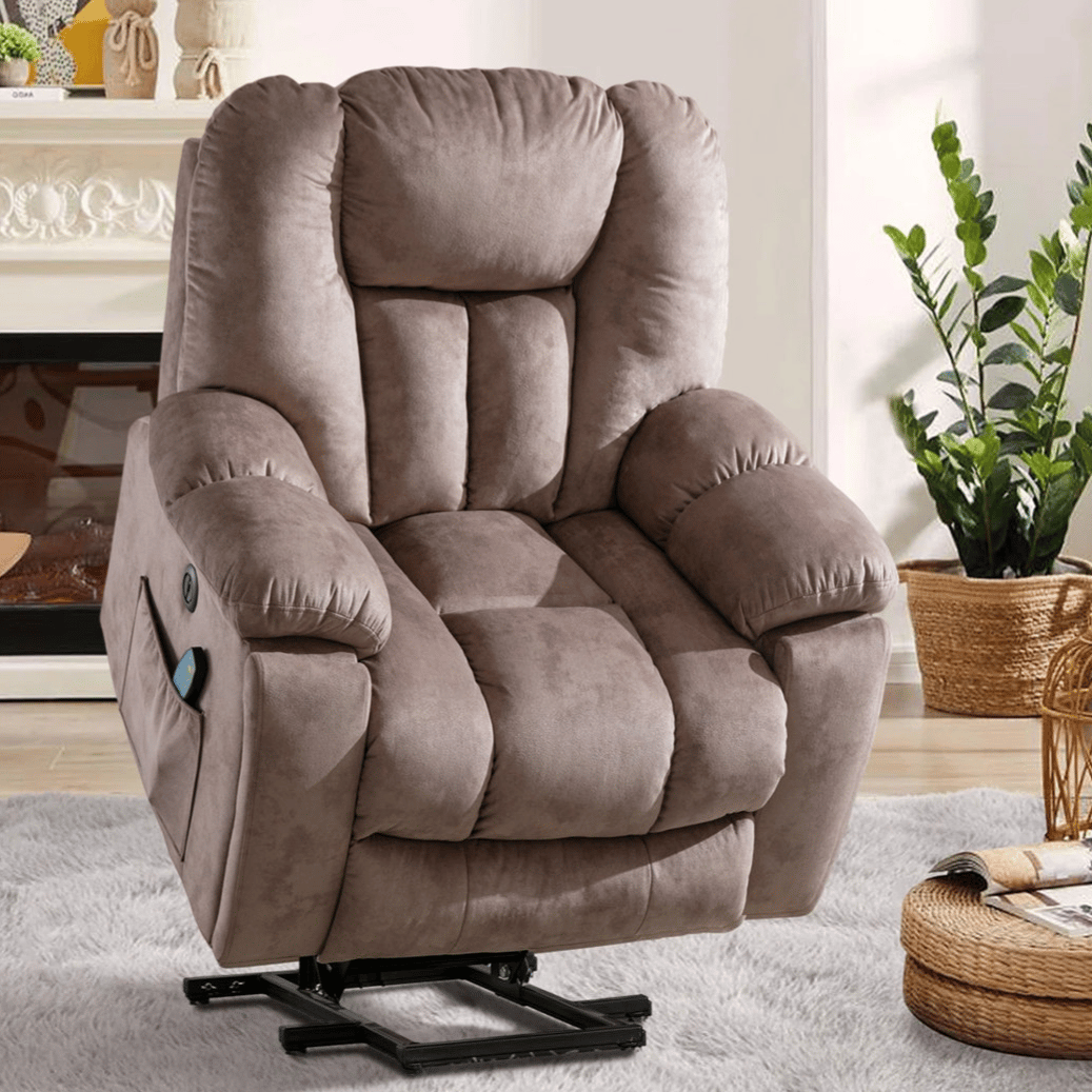 A brown upholstered power lift recliner chair with padded arms and a side pocket, set in a cozy living room with a fireplace, plants, and a coffee table.