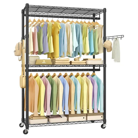 A metal clothing rack on wheels featuring two hanging bars with neatly arranged colorful clothes, a middle shelf with accessories, and a bottom shelf with storage boxes. It also includes side hooks for additional accessories.
