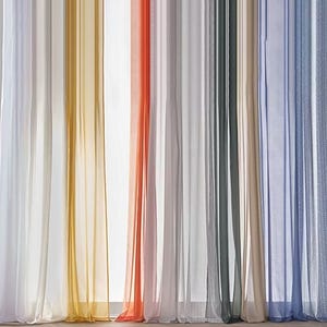 Sheer curtains in various colors, including white, yellow, orange, gray, and blue, hang vertically.