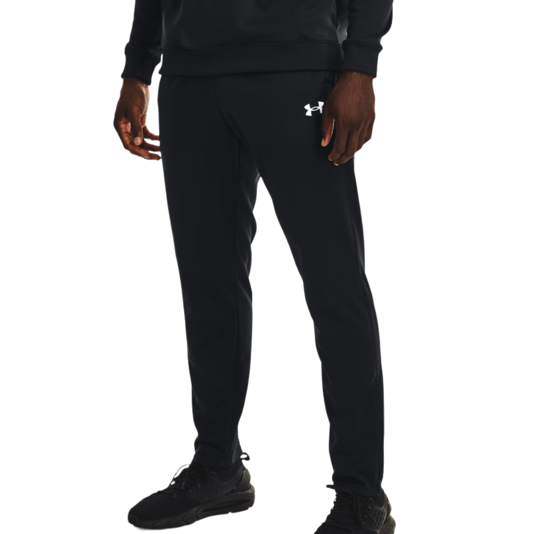 A person wearing black Under Armour jogger pants and black athletic shoes, featuring the Under Armour logo near the left pocket.