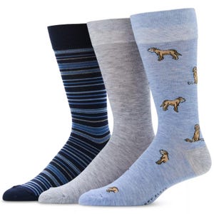 A set of three men's socks featuring patterns: navy with blue stripes, solid gray, and light blue with dog illustrations.