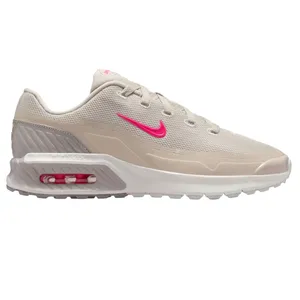 A beige Nike sneaker featuring a pink Swoosh and Air Max cushioning.