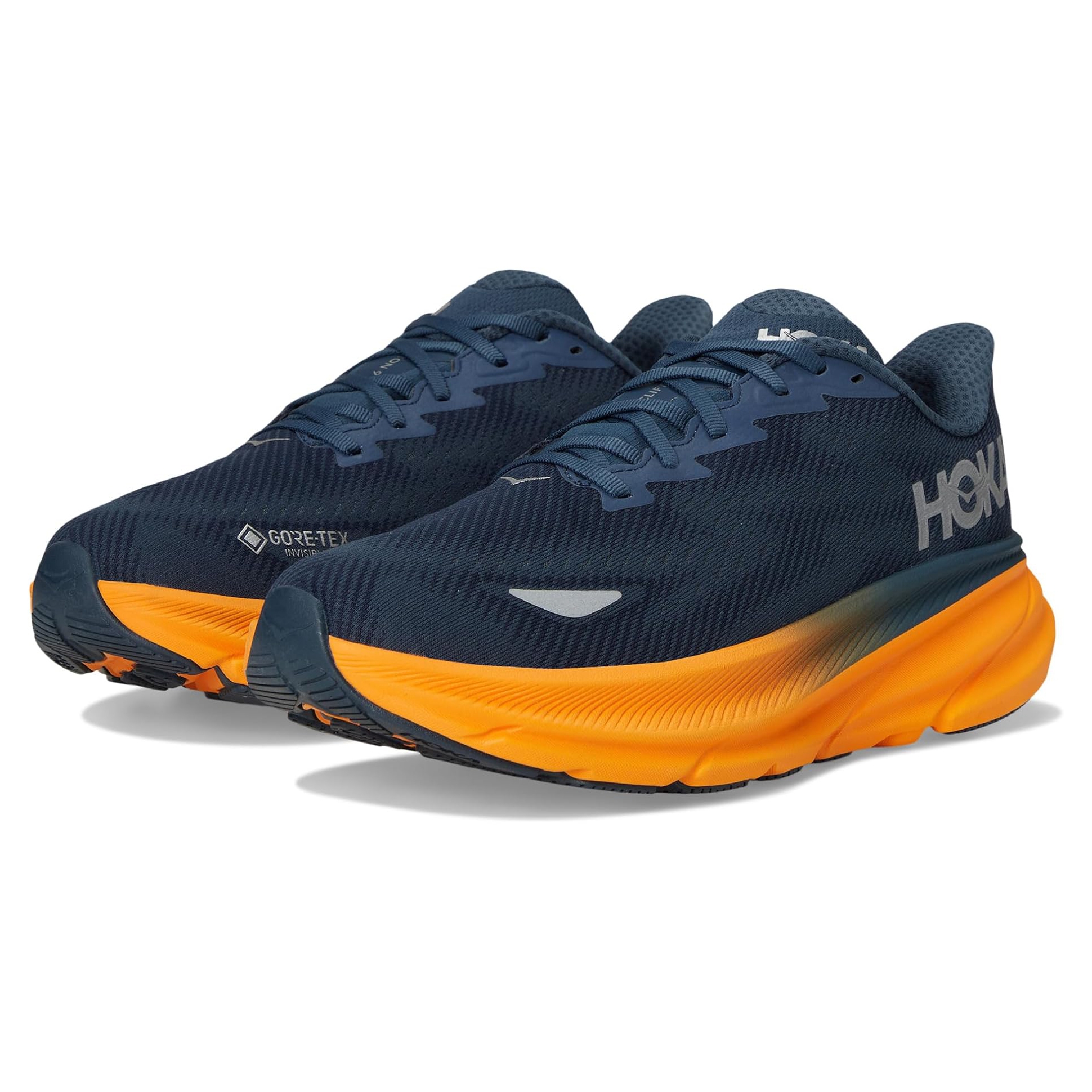 Hoka Men's Clifton 9 GTX Shoes are navy and orange with a GORE-TEX label, offering waterproof features. They have a cushioned sole and a modern, athletic design.