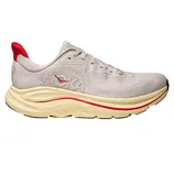 Hoka One One running shoe in a light beige color with a red accent, featuring a thick, cushioned sole.