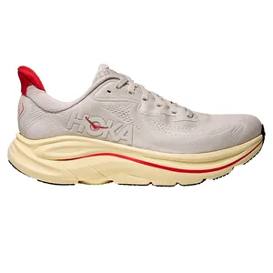 Hoka One One running shoe in a light beige color with a red accent, featuring a thick, cushioned sole.