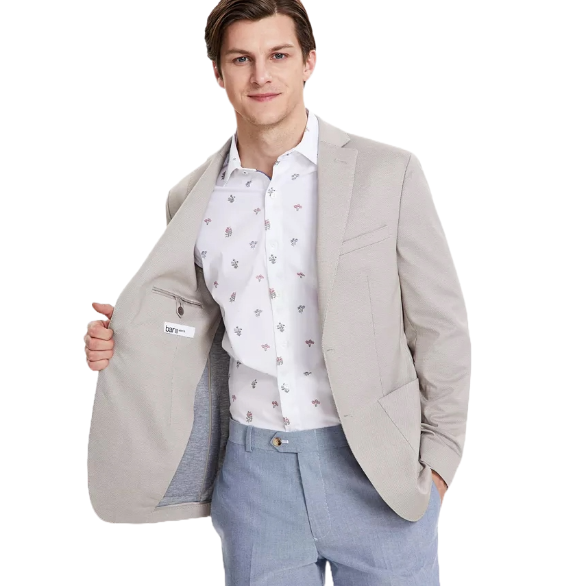 A man is wearing a slim-fit, light gray knit sport coat with a notched lapel design and buttoned cuffs.