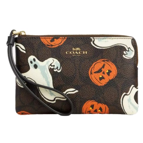A Coach wristlet with a Halloween theme featuring ghost and pumpkin illustrations.