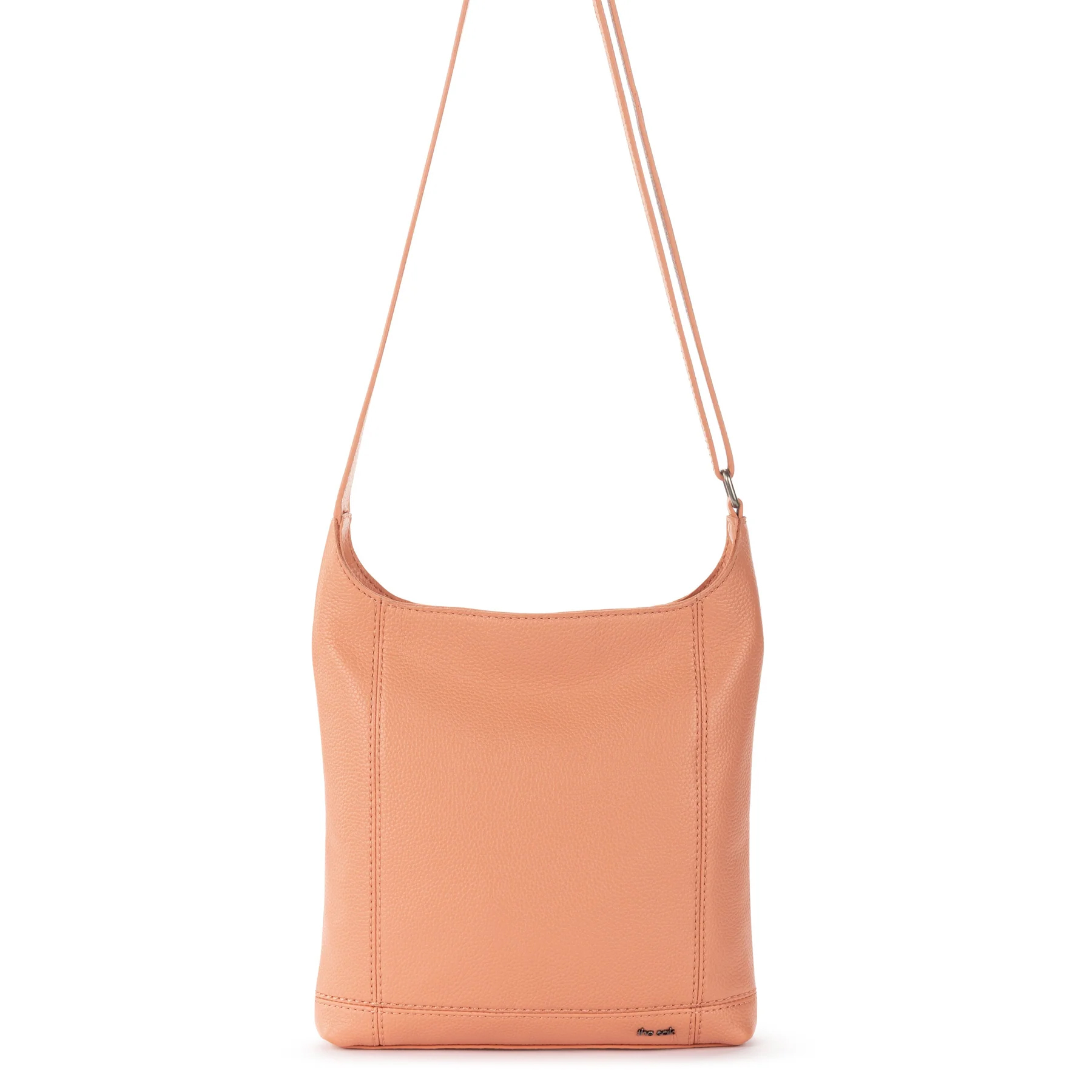 A peach-colored leather crossbody bag with a simple, rectangular design, featuring minimal stitching and a thin adjustable strap.