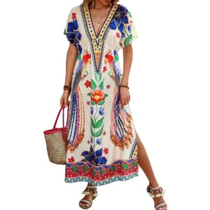 A woman wears a colorful floral maxi dress with a deep V-neck, paired with a woven straw bag and embellished sandals.