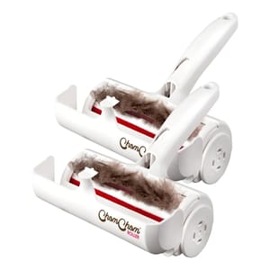 Two white pet hair rollers designed for removing pet hair, featuring a handle and a red roller surface. Each roller has a compartment to collect the hair, and the design includes side wheels for easy maneuverability.
