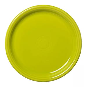 A vibrant, round, yellow-green ceramic plate with a glossy finish and subtle concentric design at the center, part of the Fiesta Bistro Dinnerware collection.