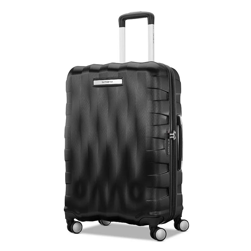 A black hard-shell suitcase with a textured surface, four wheels, and a telescopic handle is shown.