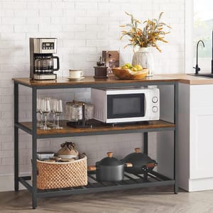 Kitchen appliances including a coffee maker and microwave are on a two-tiered kitchen island with storage baskets and cooking pots below.