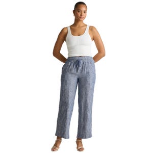Blue-striped European linen wide-leg pants with an elastic waistband and drawstring, offering a relaxed fit. Perfect for casual wear, paired here with a white tank top and open-toe sandals.