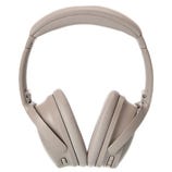 Noise-canceling over-ear headphones in a light tan color with adjustable padded headband and cushioned ear cups.