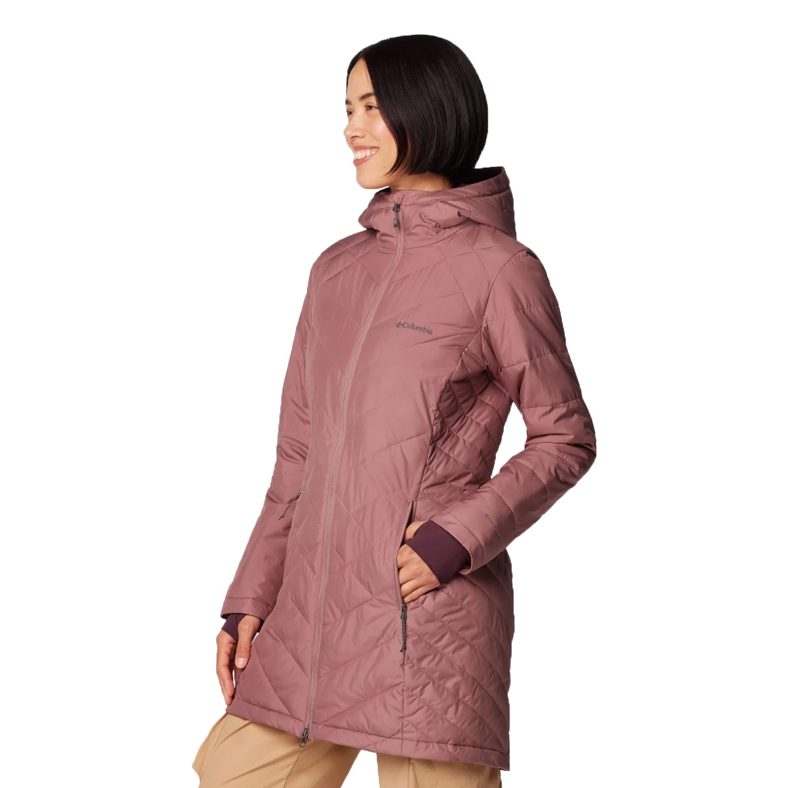 A woman is wearing a long, mauve Columbia jacket with a hood and diagonal quilted pattern. The jacket has zippered pockets and extends to mid-thigh.