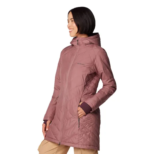 A woman is wearing a long, mauve Columbia jacket with a hood and diagonal quilted pattern. The jacket has zippered pockets and extends to mid-thigh.