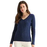 A woman is wearing a navy blue cable-knit V-neck sweater paired with off-white pants.