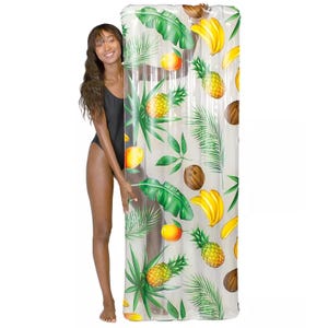Inflatable pool raft featuring a tropical fruit and leaf pattern, including pineapples, bananas, and coconuts, with approximate dimensions of 72\“x27\“.