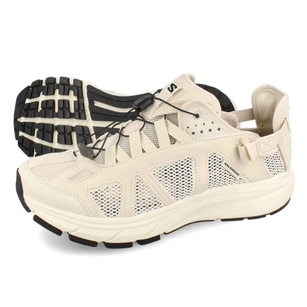 Salomon Techsonic Men's Shoes are beige with a breathable mesh upper and black outsole. They feature a quick-lace system for easy fitting and rugged soles for added traction. Ideal for outdoor activities.