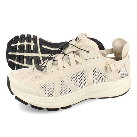 Salomon Techsonic Men's Shoes are beige with a breathable mesh upper and black outsole. They feature a quick-lace system for easy fitting and rugged soles for added traction. Ideal for outdoor activities.