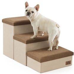 A small dog stands on a three-step pet staircase with a beige base and brown tops, designed to help pets reach higher surfaces.