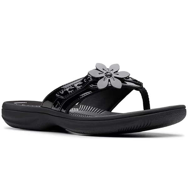 Black thong sandal with a glossy finish, featuring a prominent flower decoration on the strap and a comfortable, contoured sole.