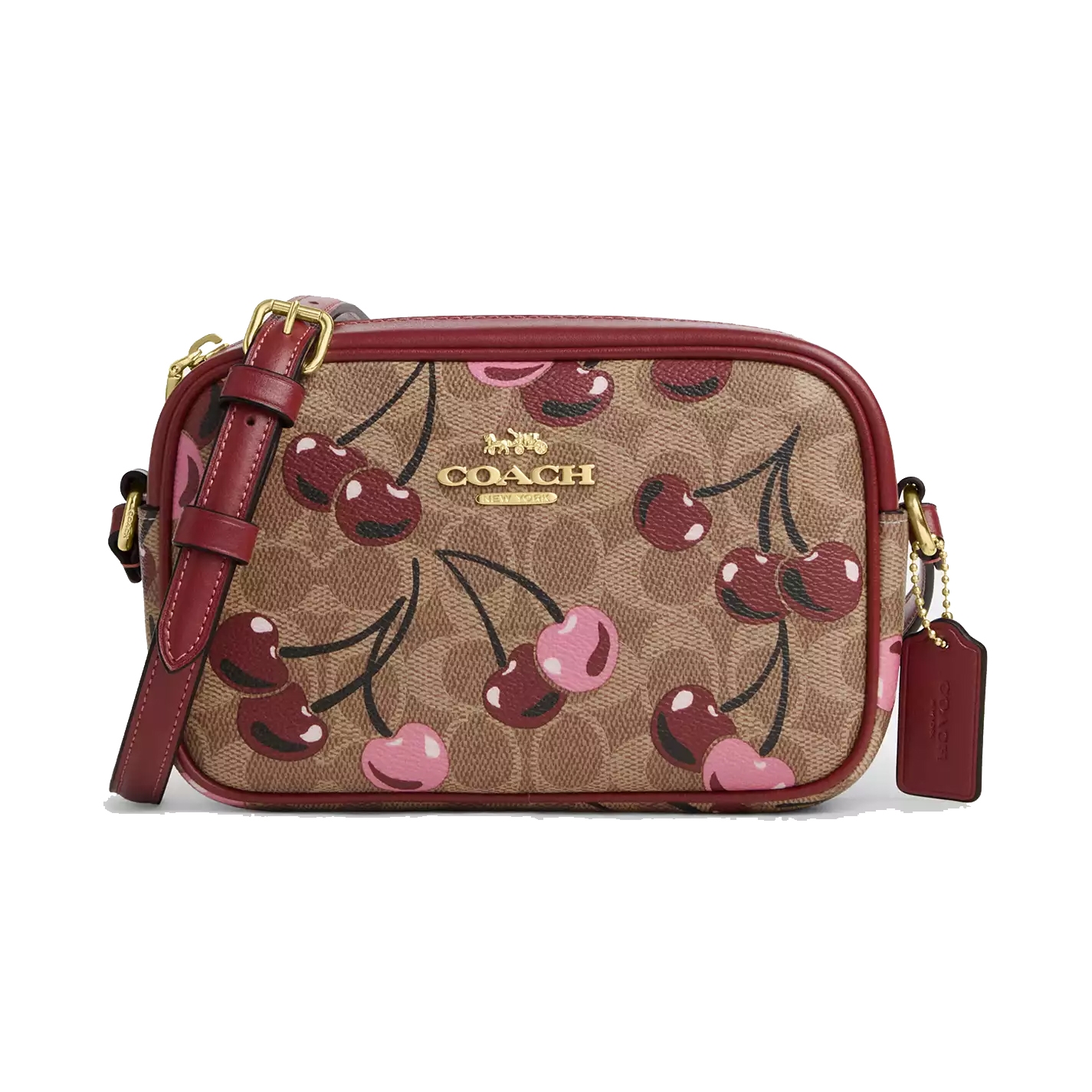 Coach Mini Jamie Camera Bag in cherry print features brown signature canvas with pink and red cherries, gold-tone hardware, a red leather strap, and a Coach tag.
