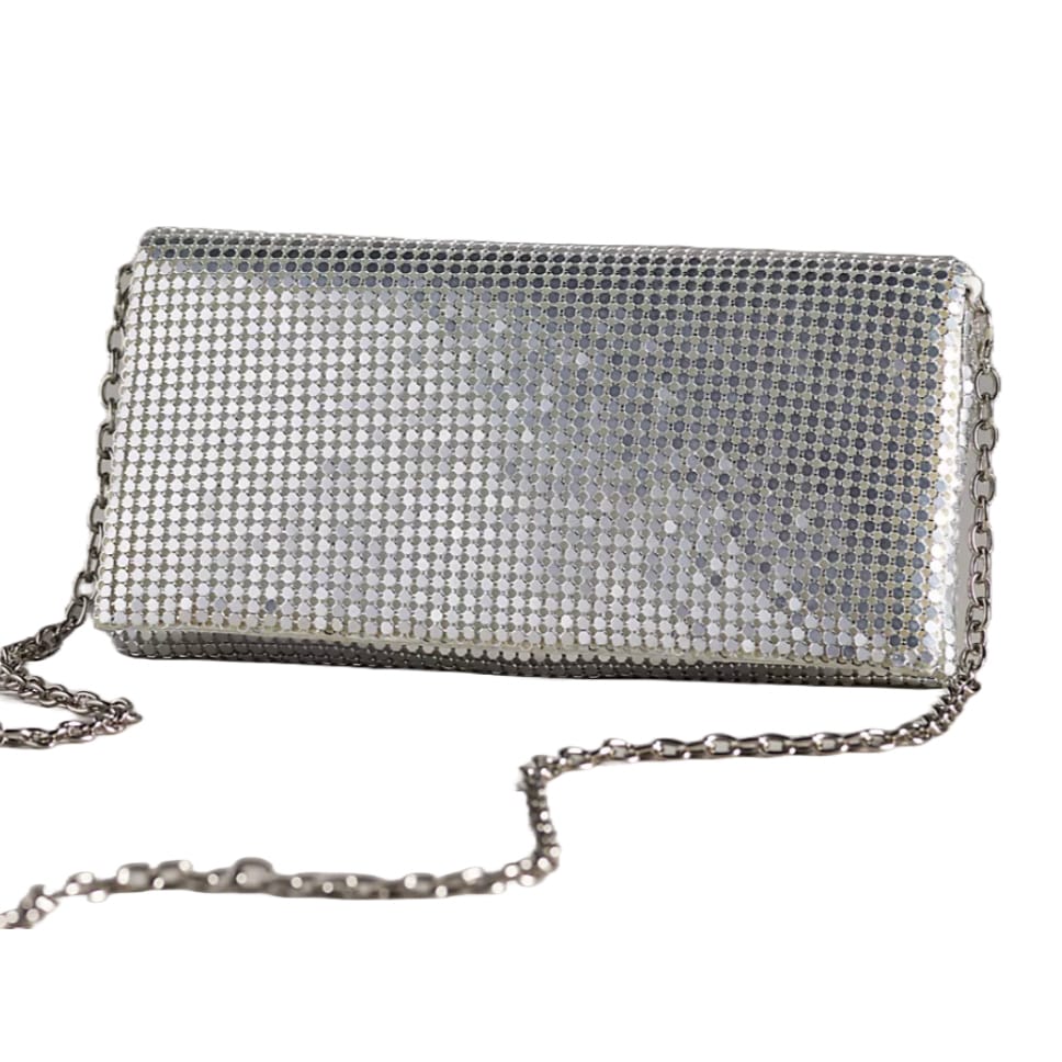 A silver metallic mesh clutch with a rectangular shape and a chain strap, featuring a shimmering, reflective surface.
