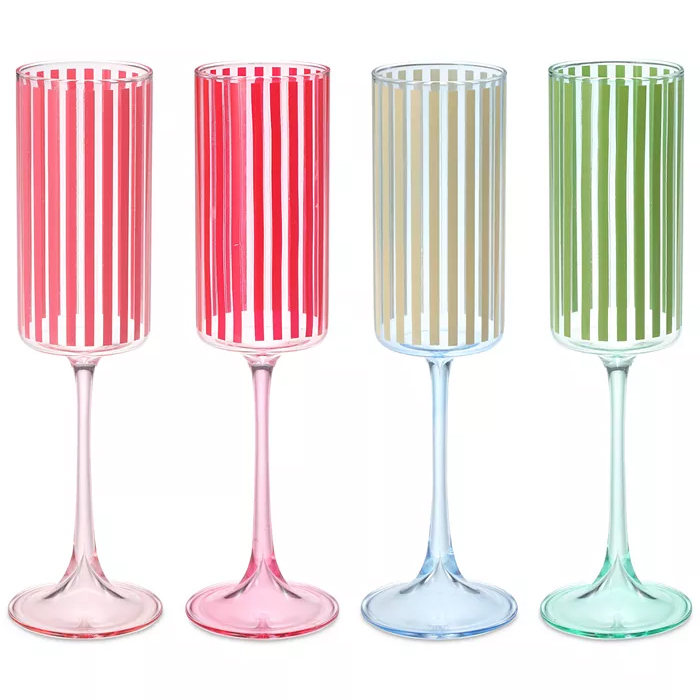 Four champagne flutes with vertical stripes in red, pink, beige, and green on clear stems.