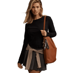 The Pilcro Seamed Top is a long-sleeve black shirt with a fitted silhouette and seam detailing. It is paired with a striped accent around the waist, enhancing its casual, stylish look.