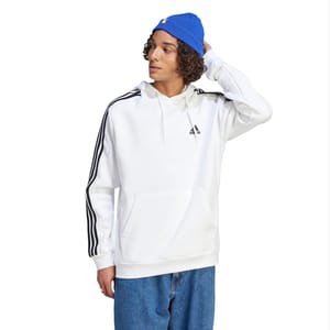 A white Adidas hoodie featuring the brand's logo on the chest and iconic three stripes on the sleeves, paired with blue jeans.