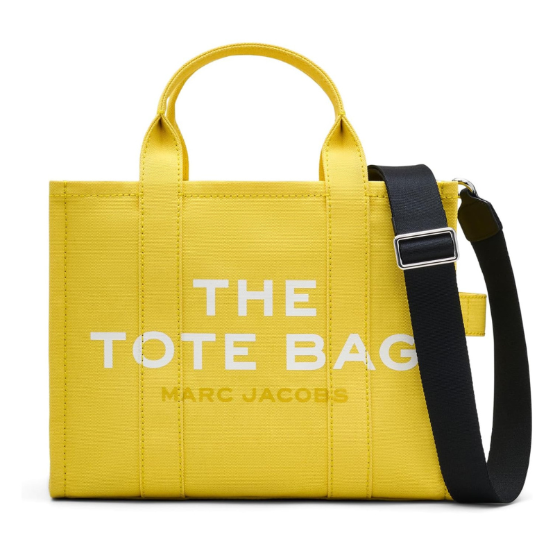 Bright yellow Marc Jacobs Medium Tote Bag with \“THE TOTE BAG\“ and \“MARC JACOBS\“ printed in white. Features dual top handles and a detachable, adjustable black shoulder strap.