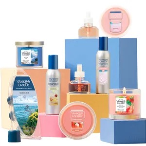 Yankee Candle products displayed include candles, room sprays, wax melts, and scented candle refills in various scents like Ocean Air, Pink Sands, and White Strawberry Bellini, arranged on colorful blocks.